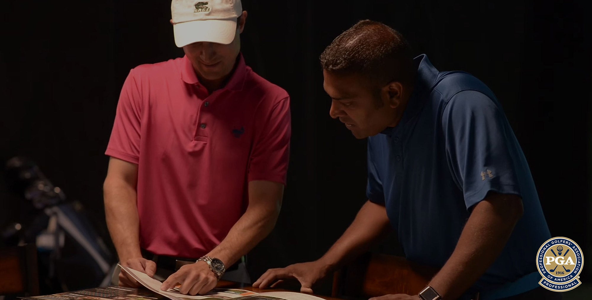 Two men looking at booklet