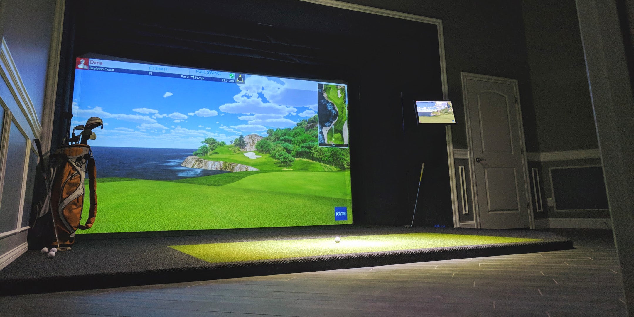 Golf simulator in spare room running golf simulation