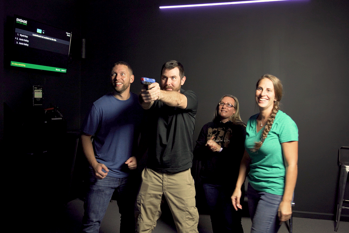 Group of people playing laser shot shooting game