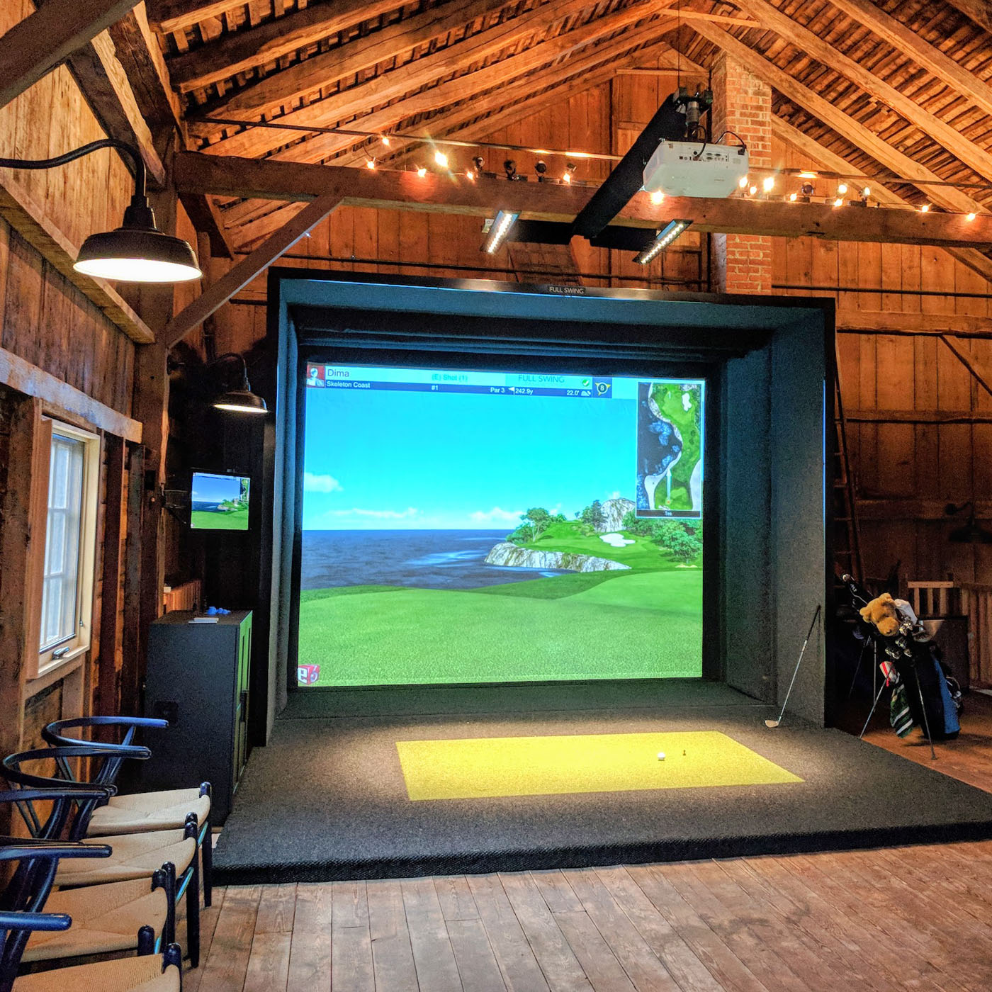 Golf simulator running golf simulation in garage